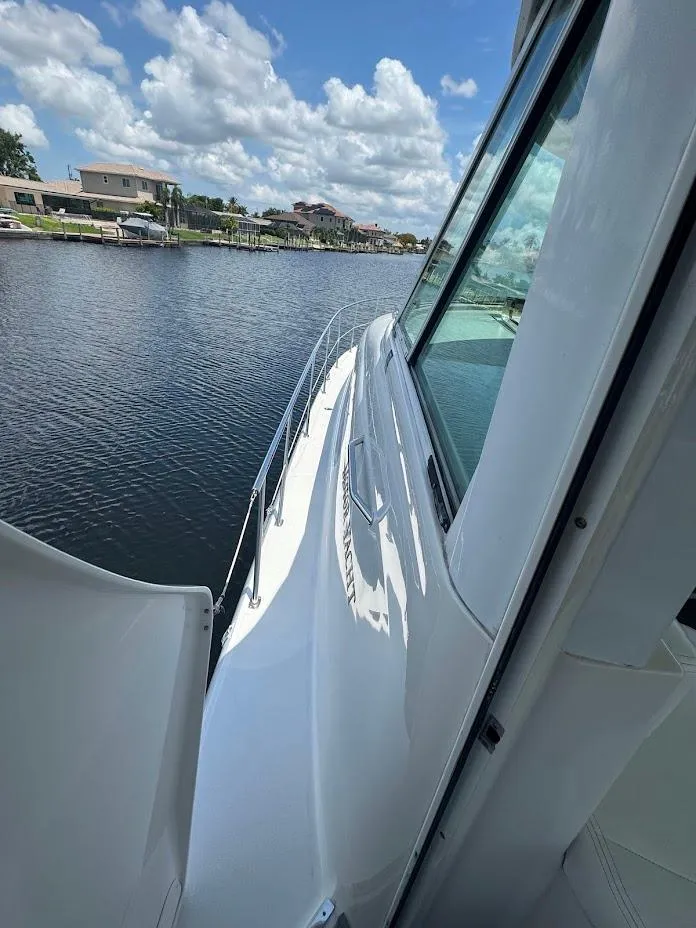 Slide: The Image of 2006 Sea Ray 40 Motor Yacht on calm water under a partly cloudy sky. - 24