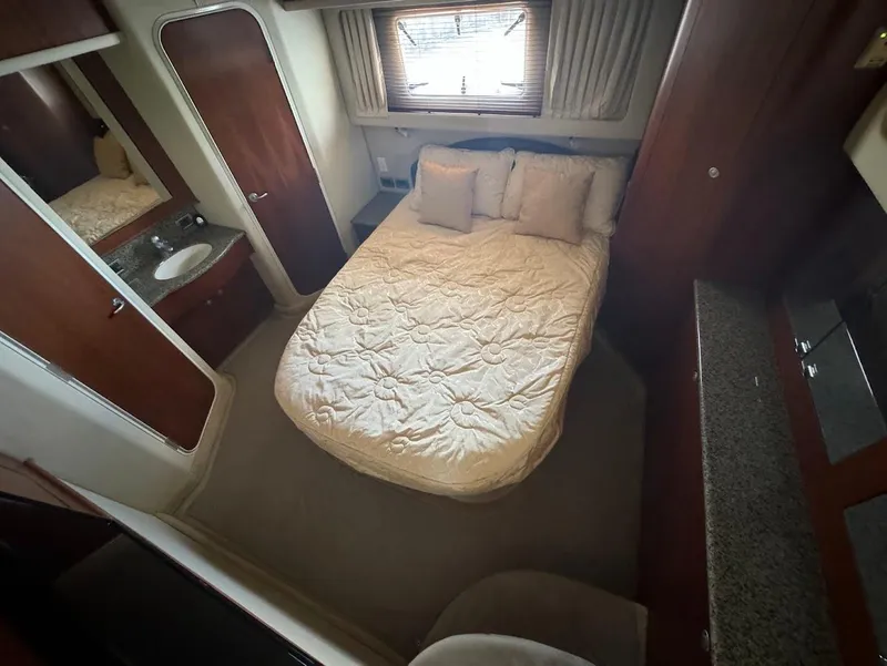 Slide: The Image of Interior of 2006 Sea Ray 40 Motor Yacht bedroom with bed and wooden cabinetry. - 26