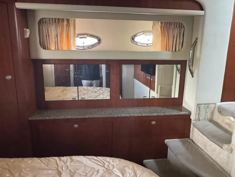 Slide: The Image of Interior of 2006 Sea Ray 40 Motor Yacht with wood cabinetry and porthole windows. - 29