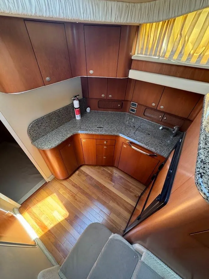 Slide: The Image of 2006 Sea Ray 40 Motor Yacht kitchen with wood cabinets and granite countertops. - 30