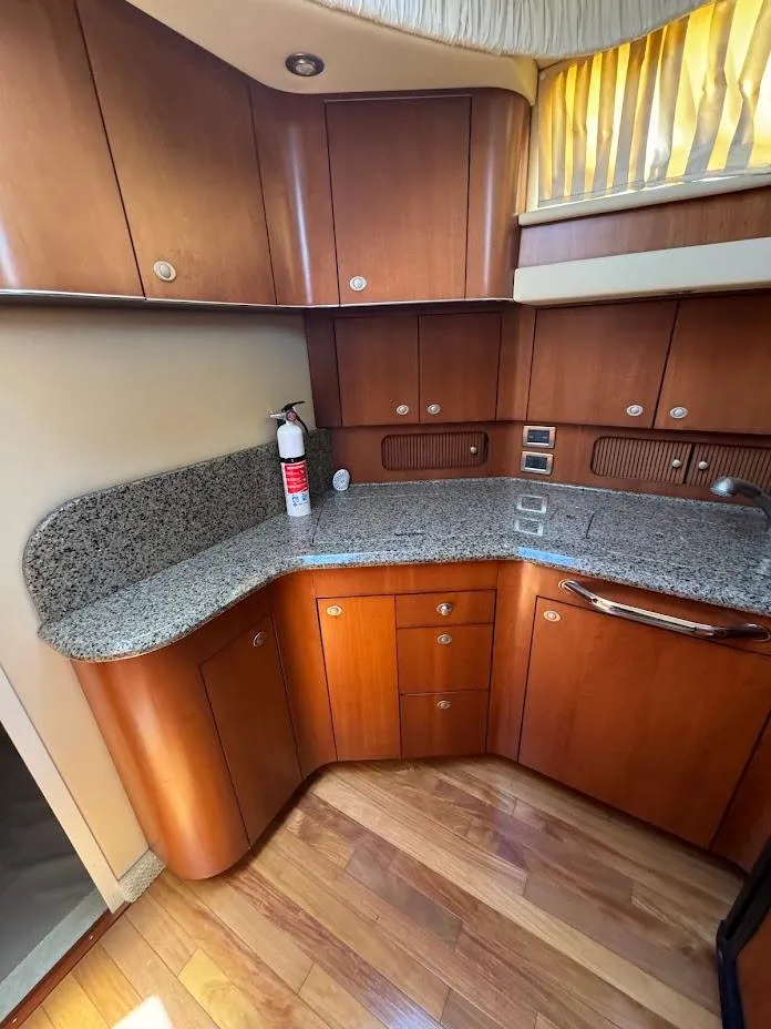 Slide: The Image of 2006 Sea Ray 40 Motor Yacht kitchen with wood cabinets and granite countertops. - 32
