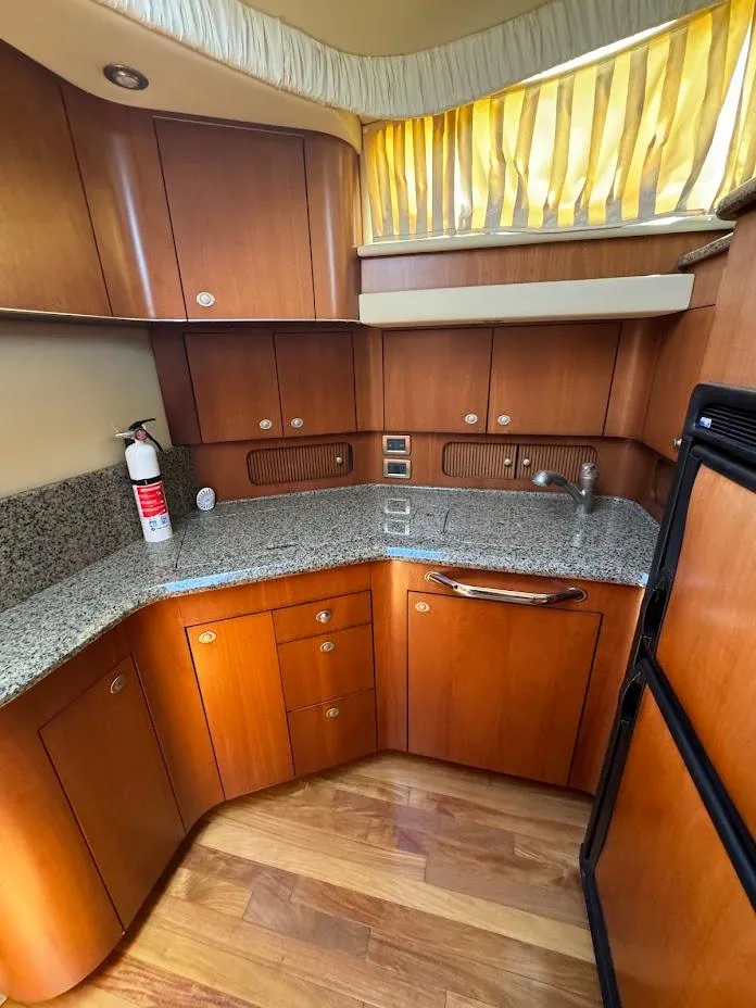 Slide: The Image of 2006 Sea Ray 40 Motor Yacht kitchen with wood cabinets and granite countertops. - 33