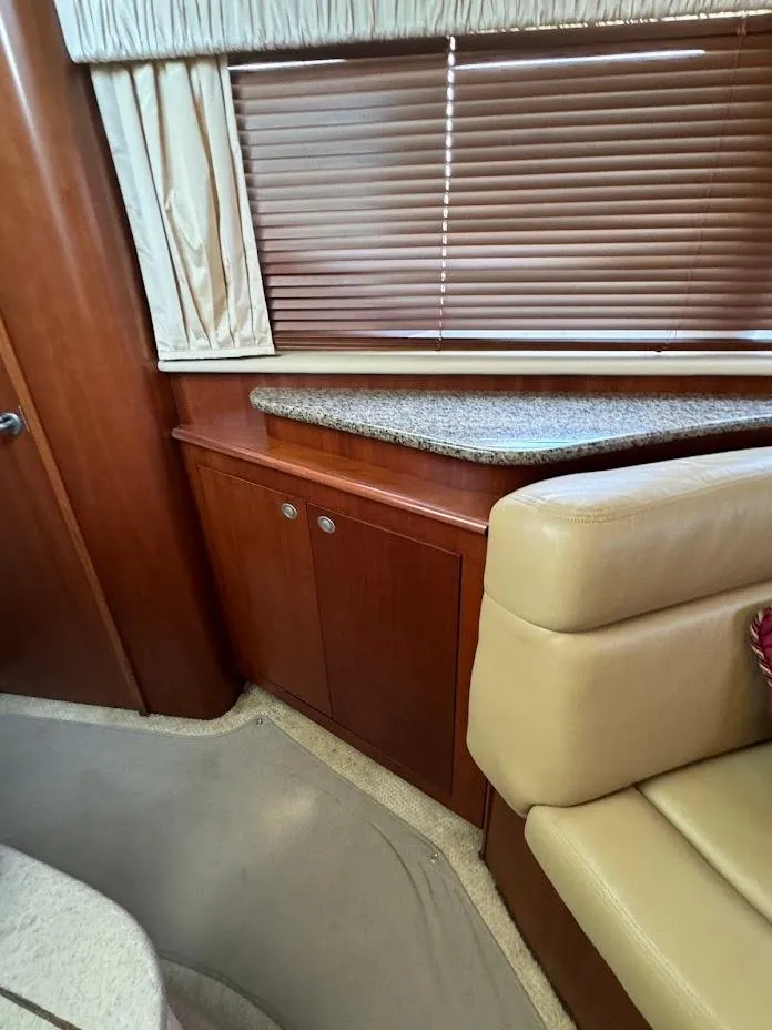 Slide: The Image of 2006 Sea Ray 40 Motor Yacht interior with wood cabinetry and beige seating. - 36