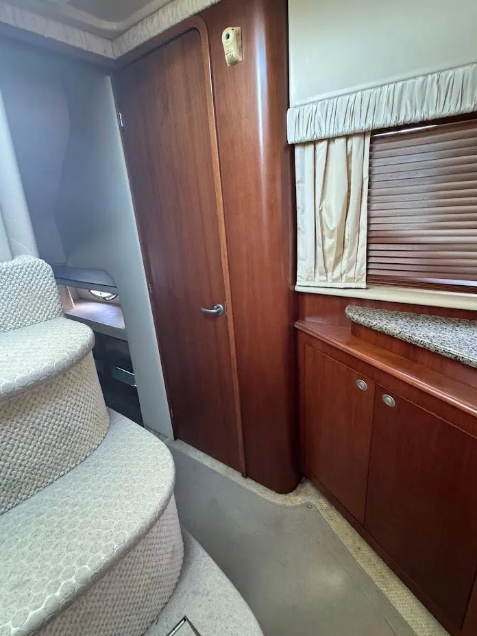 Slide: The Image of 2006 Sea Ray 40 Motor Yacht interior with stairs, wooden cabinetry, and window blinds. - 37