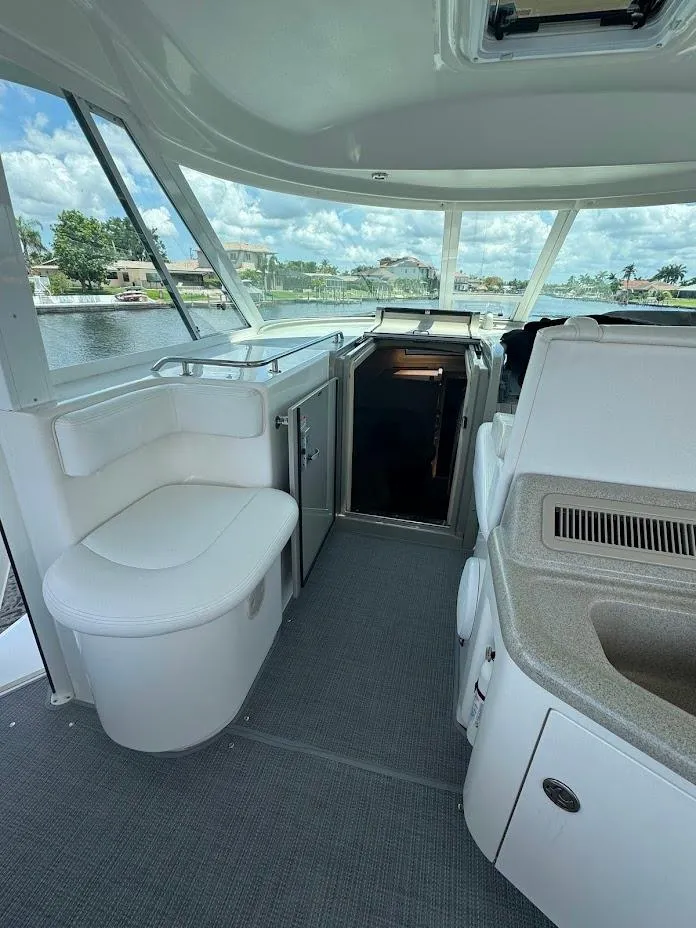 Slide: The Image of Interior of 2006 Sea Ray 40 Motor Yacht with seating and helm, overlooking water. - 7