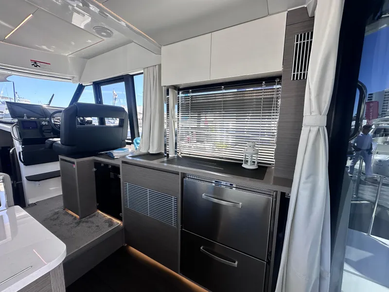 Slide: The Image of Modern interior of 2025 Jeanneau 1295 yacht with sleek kitchen and helm station. - 14