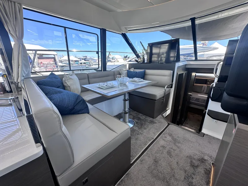 Slide: The Image of Luxurious interior of 2025 Jeanneau 1295 yacht with elegant seating and dining area. - 15