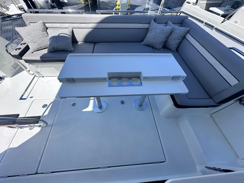 Slide: The Image of 2025 Jeanneau 1295 yacht interior with sleek seating and modern table design. - 6