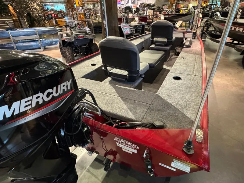 Slide: The Image of 2025 Tracker Panfish 17 boat with Mercury engine, displayed indoors. - 2