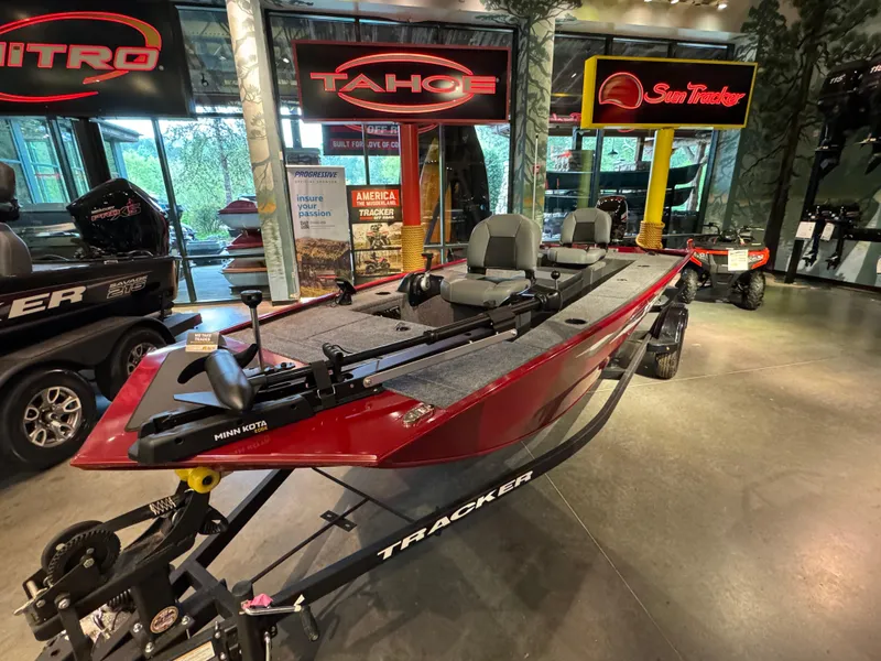 Slide: The Image of 2025 Tracker Panfish 17 boat displayed in showroom with vibrant red finish. - 3
