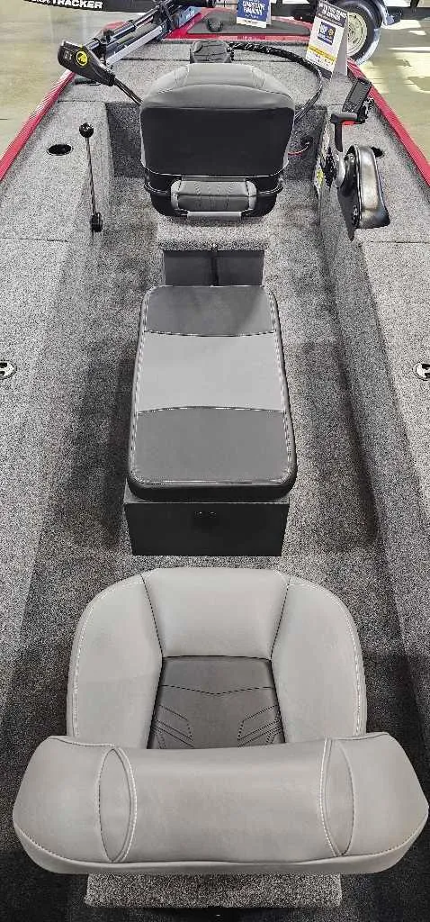 Slide: The Image of 2025 Tracker Panfish 17 boat interior with gray seating and carpeted flooring. - 3