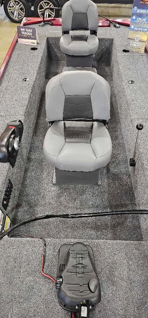Slide: The Image of 2025 Tracker Panfish 17 boat interior with three gray seats and control panel. - 4