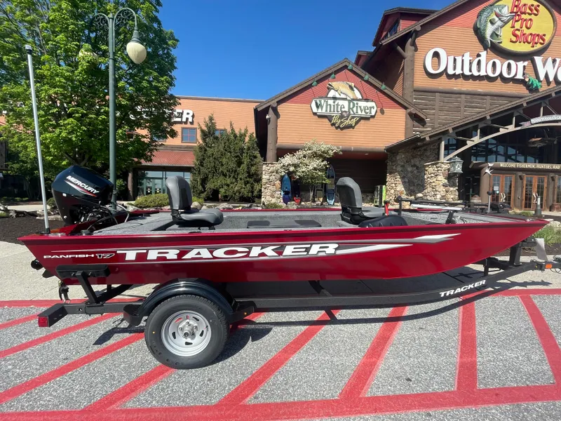 The Image of 2025 Tracker Panfish 17 boat displayed outside Outdoor World, with trade-in options available. - 0