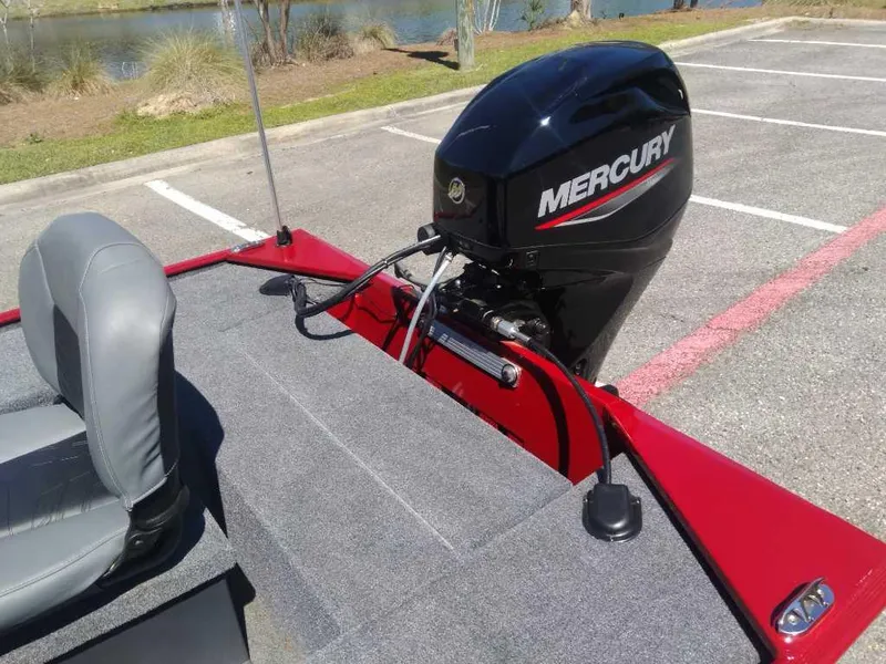 Slide: The Image of 2025 Tracker Panfish 17 boat with Mercury outboard motor in parking lot. - 12