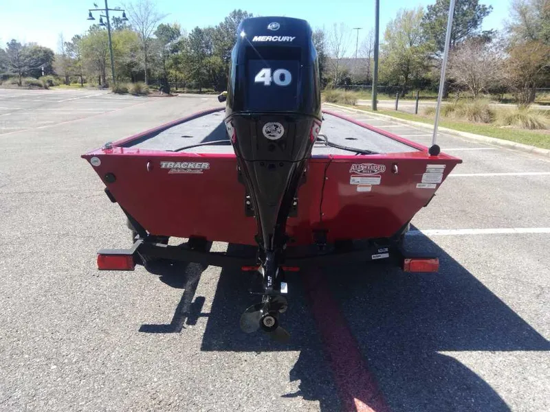 Slide: The Image of 2025 Tracker Panfish 17 boat with Mercury 40 engine in a parking lot. - 2
