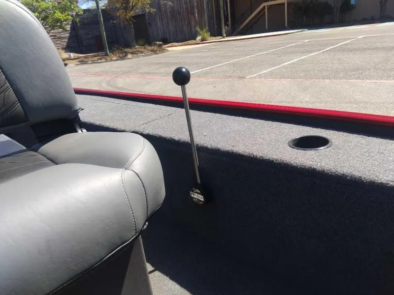 Slide: The Image of 2025 Tracker Panfish 17 boat interior with gray seating and control lever. - 9