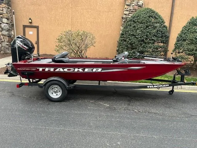 Slide: The Image of 2025 Tracker Panfish 17 boat on trailer, red color, parked outdoors. - 36