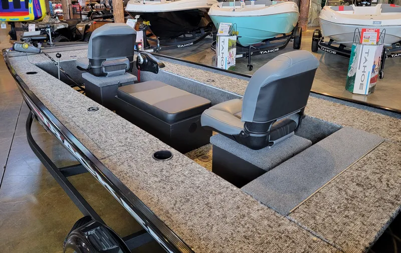 Slide: The Image of 2025 Tracker Panfish 17 boat with dual seating and carpeted deck in showroom. - 3