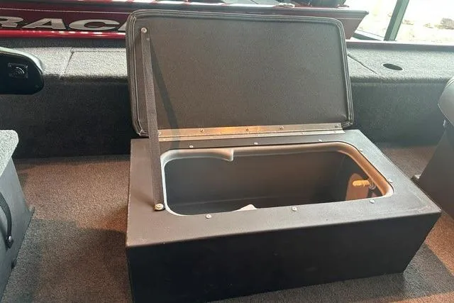 Slide: The Image of 2025 Tracker Panfish 17 boat storage compartment with open lid, showcasing interior space. - 11