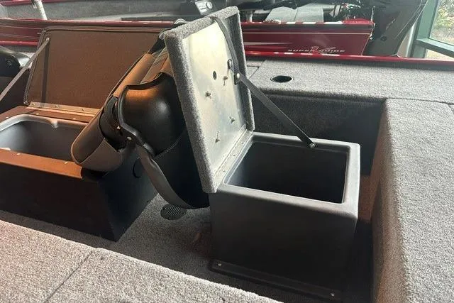 Slide: The Image of 2025 Tracker Panfish 17 boat storage compartment with open lid, showcasing interior features. - 7