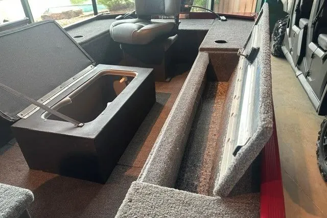 Slide: The Image of 2025 Tracker Panfish 17 boat interior with open storage compartments and seating. - 6