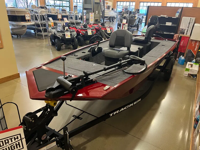 The Image of 2025 Tracker Panfish 17 boat displayed in showroom, featuring sleek design and modern seating. - 0