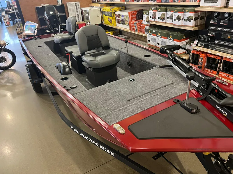 Slide: The Image of 2025 Tracker Panfish 17 boat with dual seats, displayed indoors. - 2