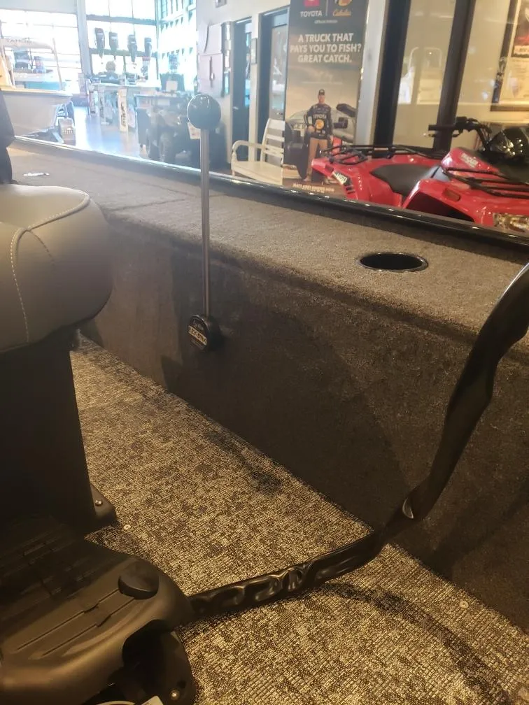 Slide: The Image of 2025 Tracker Panfish 17 boat interior with fishing rod holder and carpeted deck. - 3