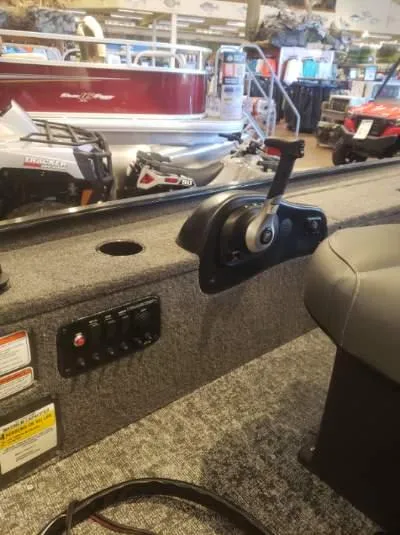 Slide: The Image of 2025 Tracker Panfish 17 boat interior with control panel and throttle lever. - 4