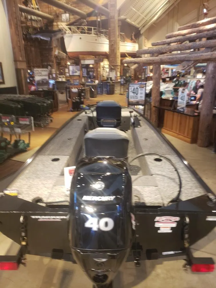 Slide: The Image of 2025 Tracker Panfish 17 boat with Mercury 40 engine displayed indoors. - 6