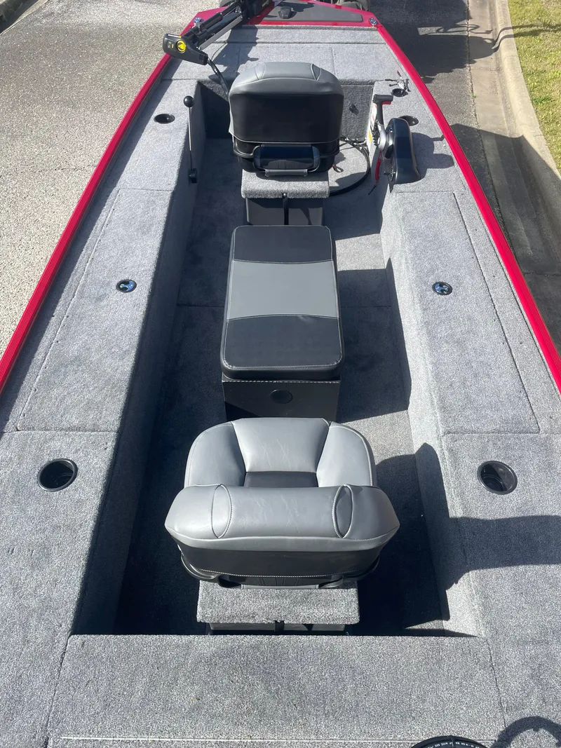 Slide: The Image of 2025 Tracker Panfish 17 boat interior with gray seating and red trim. - 2