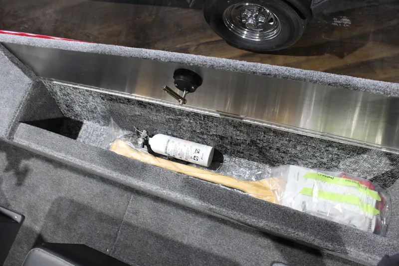 Slide: The Image of Storage compartment in 2025 Tracker Panfish 17 boat with fire extinguisher and paddle. - 13