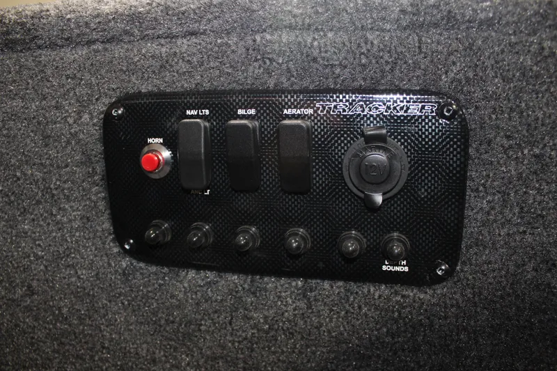 Slide: The Image of Control panel of 2025 Tracker Panfish 17 boat with switches and horn button. - 18