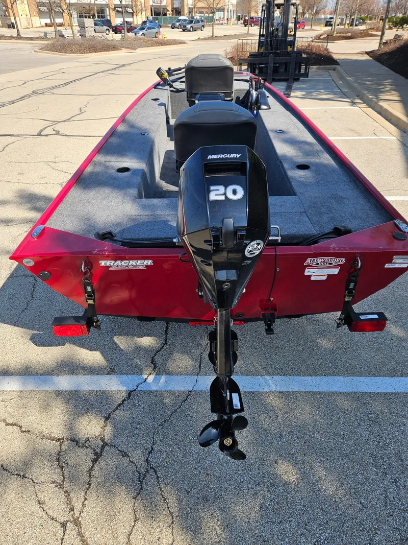 Slide: The Image of 2025 Tracker Panfish 17 boat with Mercury 20 outboard motor, parked in a lot. - 6