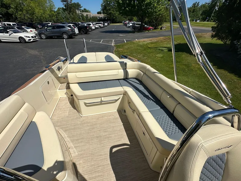 Slide: The Image of 2023 Chris-Craft Launch 25 GT boat interior with beige seating and chrome accents. - 10