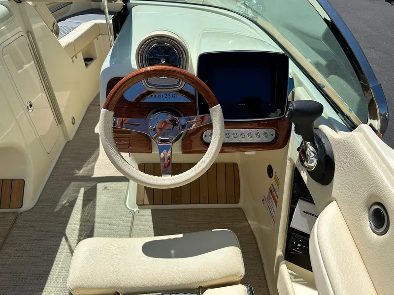 Slide: The Image of 2023 Chris-Craft Launch 25 GT boat interior with steering wheel and dashboard controls. - 3