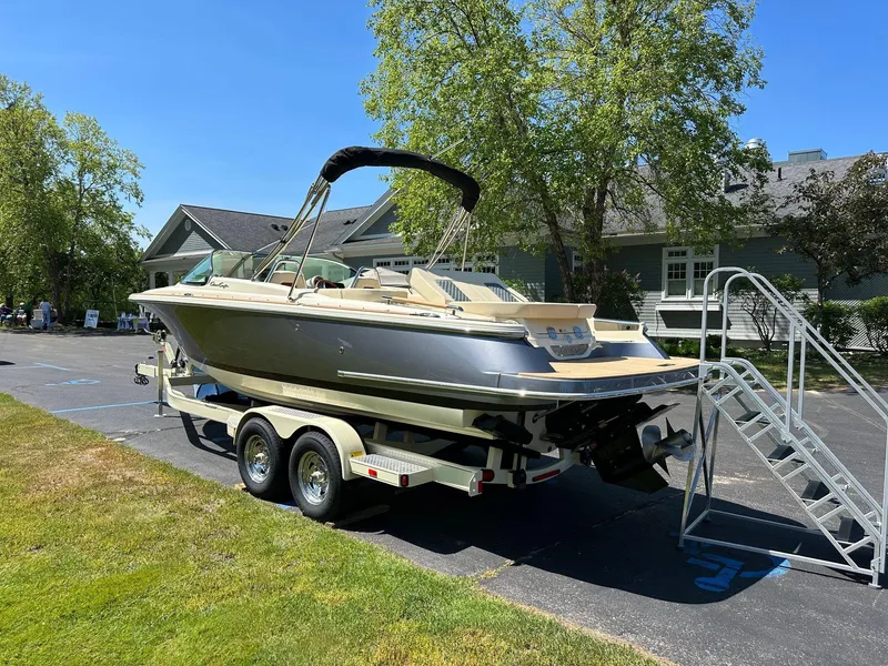 Slide: The Image of 2023 Chris-Craft Launch 25 GT boat on trailer, parked outdoors on a sunny day. - 5