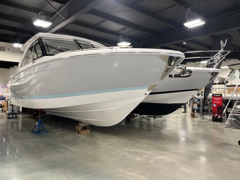 Slide: The Image of 2025 Regal LS36 boat displayed indoors on stands. - 1