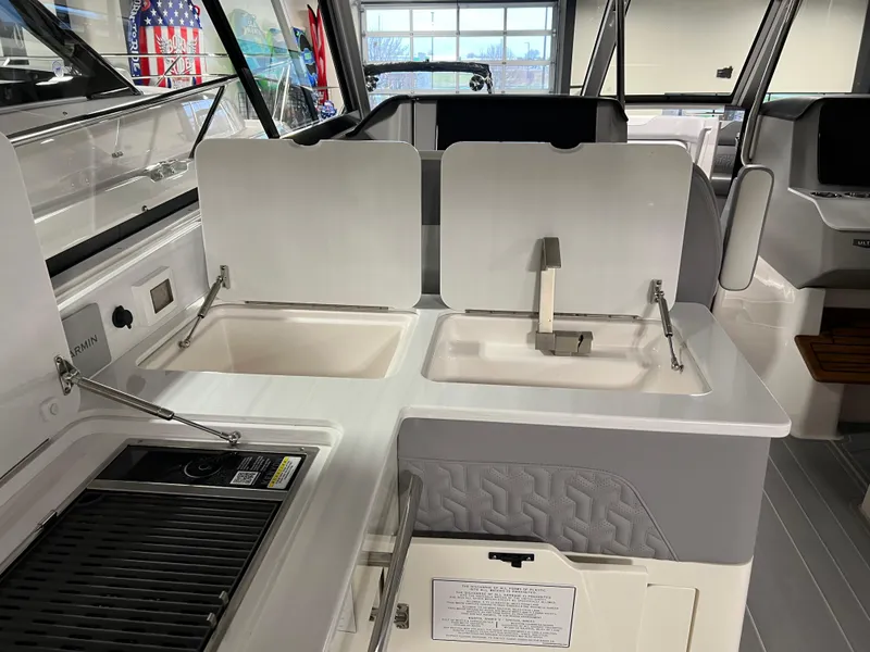 Slide: The Image of 2025 Regal LS36 boat interior with dual sinks and grill in cockpit area. - 11