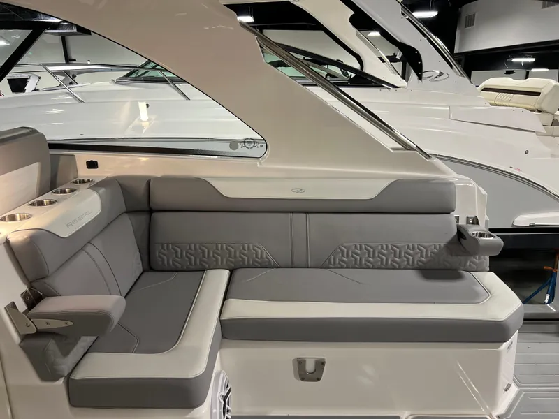 Slide: The Image of 2025 Regal LS36 boat interior with gray seating and cup holders. - 14