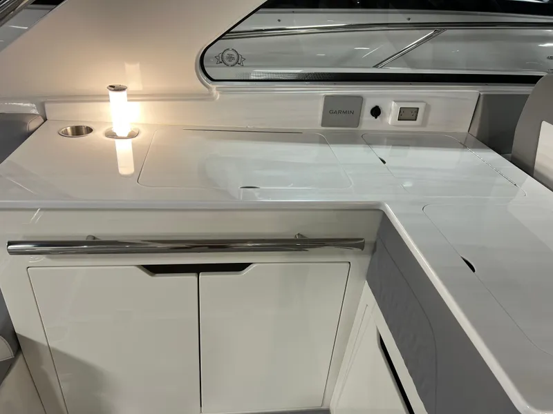 Slide: The Image of 2025 Regal LS36 yacht interior with sleek kitchen counter and modern lighting. - 16