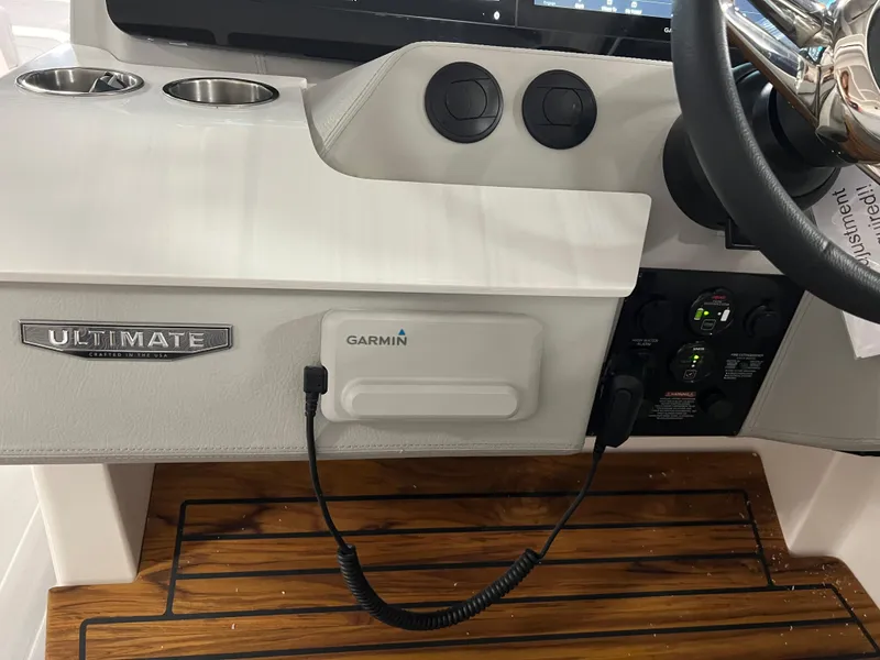 Slide: The Image of 2025 Regal LS36 boat dashboard with Garmin device and steering wheel. - 19