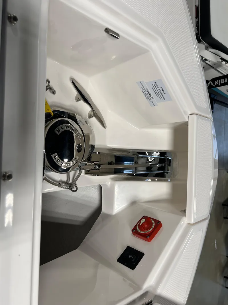 Slide: The Image of 2025 Regal LS36 boat anchor compartment with winch and control panel. - 25