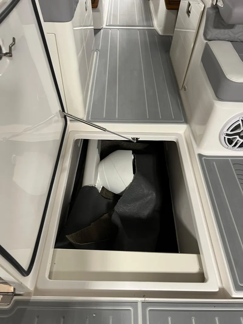Slide: The Image of 2025 Regal LS36 boat storage compartment with open hatch and visible interior. - 30