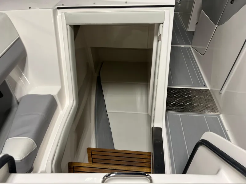 Slide: The Image of 2025 Regal LS36 boat interior with wooden steps and sleek, modern design. - 32