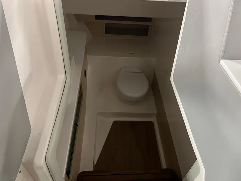 Slide: The Image of 2025 Regal LS36 boat interior bathroom with compact toilet and modern design. - 37