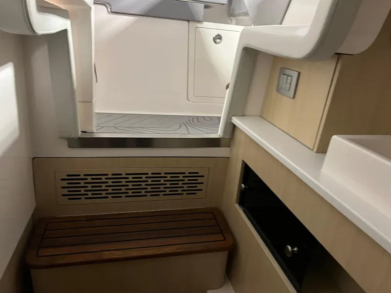 Slide: The Image of Interior of 2025 Regal LS36 boat, featuring modern seating and storage design. - 38