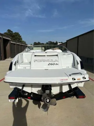 Slide: The Image of 2008 Formula 260 Bow Rider boat, rear view, parked on a sunny day. - 13