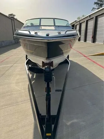 Slide: The Image of 2008 Formula 260 Bow Rider boat on trailer, parked outdoors near storage units. - 19