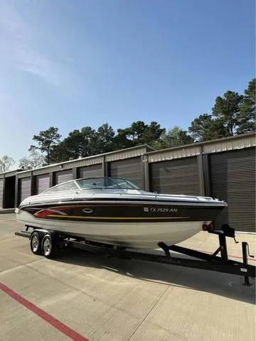 Slide: The Image of 2008 Formula 260 Bow Rider boat on trailer, parked near storage units. - 22